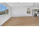 Living room featuring hardwood floors, a modern chandelier, and large windows at 6664 Rutgers Dr, Las Vegas, NV 89156