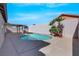 Backyard pool with a covered patio and block wall, surrounded by desert landscaping and clear blue skies at 6664 Rutgers Dr, Las Vegas, NV 89156