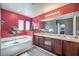 Bathroom with large vanity, tub, and natural light at 6687 Higger Tor Ave, Las Vegas, NV 89139