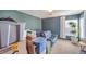 Bedroom with a blue sofa, boxes, potted plant, and natural light from the window at 6687 Higger Tor Ave, Las Vegas, NV 89139