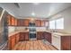 Well-lit kitchen with stainless steel appliances, wooden cabinets, and neutral countertops at 6687 Higger Tor Ave, Las Vegas, NV 89139