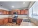 Well-lit kitchen features wooden cabinetry, stainless steel appliances, laminate countertops, and a large window at 6687 Higger Tor Ave, Las Vegas, NV 89139