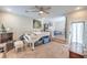 Spacious living room featuring carpet, large window, ceiling fan, and dining area in the background at 6687 Higger Tor Ave, Las Vegas, NV 89139