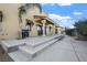 Wide backyard patio with steps leading up to the house, offering ample space for entertaining at 6760 Hinson St, Las Vegas, NV 89118