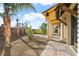 Well landscaped backyard with a covered patio and mature palm trees at 6760 Hinson St, Las Vegas, NV 89118