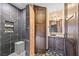 Bathroom with tiled shower, vessel sink, and decorative tile floor at 6760 Hinson St, Las Vegas, NV 89118