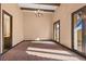 This bedroom features hardwood trim, a striking chandelier, and abundant natural light at 6760 Hinson St, Las Vegas, NV 89118