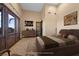 Staged bedroom featuring double doors, a large rug, and wood accents at 6760 Hinson St, Las Vegas, NV 89118