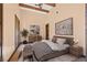 Bright bedroom boasts a vaulted ceiling with wooden beams, and a sliding door to the outside at 6760 Hinson St, Las Vegas, NV 89118