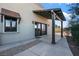 Exterior of a home featuring a wood pergola and dark framed windows at 6760 Hinson St, Las Vegas, NV 89118