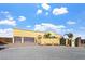 Beautiful exterior showing the house's facade, a three-car garage, gate, and an attractive landscaped front yard at 6760 Hinson St, Las Vegas, NV 89118