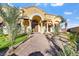 Stunning home featuring an arched entryway, double doors, and beautiful desert landscaping at 6760 Hinson St, Las Vegas, NV 89118