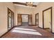 Spacious living room with an ornate carpet, neutral walls and wooden beam ceiling at 6760 Hinson St, Las Vegas, NV 89118