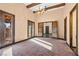 Bright living room with neutral walls and wood beam ceiling, featuring double doors at 6760 Hinson St, Las Vegas, NV 89118