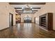 Spacious living room featuring high ceilings, exposed beams, and hardwood floors throughout at 6760 Hinson St, Las Vegas, NV 89118