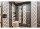 Modern tiled shower with a built-in bench and rainfall shower head at 6760 Hinson St, Las Vegas, NV 89118