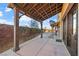 Side yard featuring a wooden pergola, desert landscaping, and a cozy outdoor space at 6760 Hinson St, Las Vegas, NV 89118