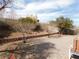 Spacious backyard featuring low walls, gravel, mature trees and a patio area ideal for outdoor entertaining at 710 Strawberry Pl, Henderson, NV 89002