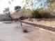 Gravel backyard features mature trees, shrubs, and a brick retaining wall at 710 Strawberry Pl, Henderson, NV 89002