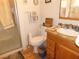 Modest bathroom features a shower with glass doors, toilet, and a wooden vanity sink at 710 Strawberry Pl, Henderson, NV 89002