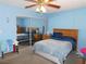 Bedroom featuring a wooden bed frame, ceiling fan, and sliding mirror closet doors at 710 Strawberry Pl, Henderson, NV 89002