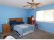 Cozy bedroom featuring a wooden bed frame, ceiling fan, and a bright, inviting ambiance at 710 Strawberry Pl, Henderson, NV 89002