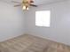 Cozy bedroom featuring neutral walls, carpet, a window, and a ceiling fan at 710 Strawberry Pl, Henderson, NV 89002