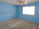 Bedroom with blue walls and neutral carpet, a ceiling fan and one window at 710 Strawberry Pl, Henderson, NV 89002