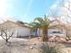 Charming single-story home featuring a desert landscape and a decorative pineapple palm tree in the front yard at 710 Strawberry Pl, Henderson, NV 89002