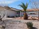 Charming single-story home featuring a desert landscape and a decorative pineapple palm tree in the front yard at 710 Strawberry Pl, Henderson, NV 89002