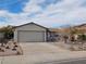 Detached garage with a white door and concrete driveway, close to the house at 710 Strawberry Pl, Henderson, NV 89002