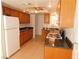 Traditional kitchen with wooden cabinets, granite counters, and a white refrigerator and gas stove at 710 Strawberry Pl, Henderson, NV 89002