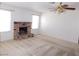 Spacious living room featuring a brick fireplace and ceiling fan with light at 710 Strawberry Pl, Henderson, NV 89002