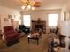 Cozy living room with a brick fireplace, plush seating, and natural light from large windows at 710 Strawberry Pl, Henderson, NV 89002