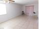 Living room features tiled floors and light filled sliding glass door at 710 Strawberry Pl, Henderson, NV 89002