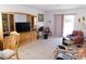 Bright living room with tile floors, sliding glass doors, and a spacious layout for comfortable living at 710 Strawberry Pl, Henderson, NV 89002