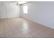 Bright room with tiled floor, features a ceiling fan and view to a window at 710 Strawberry Pl, Henderson, NV 89002