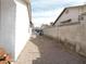 Gravel-covered side yard with block wall and partial view of neighboring houses at 710 Strawberry Pl, Henderson, NV 89002