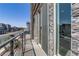 Balcony features black railings, stone facade, and large glass doors with great natural light at 7180 Grace Estate Ave, Las Vegas, NV 89113