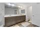 Bathroom features a double sink vanity with modern lighting, neutral color palette, and tile floors at 7180 Grace Estate Ave, Las Vegas, NV 89113