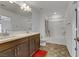 Spacious bathroom with dual sinks, dark wood cabinetry, and tiled flooring at 7180 Grace Estate Ave, Las Vegas, NV 89113