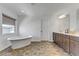 Bright bathroom with standalone tub, dual vanity and modern fixtures at 7180 Grace Estate Ave, Las Vegas, NV 89113