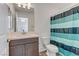 Bathroom featuring a single sink vanity and a tub with an aqua striped shower curtain at 7180 Grace Estate Ave, Las Vegas, NV 89113