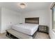 Comfortable bedroom with white walls, gray furniture and a large window for natural light at 7180 Grace Estate Ave, Las Vegas, NV 89113