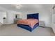 Large bedroom with blue accent bed frame, neutral walls, and carpet at 7180 Grace Estate Ave, Las Vegas, NV 89113