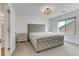 Bedroom showcases tufted headboard, stylish light fixture and bright, neutral tones at 7180 Grace Estate Ave, Las Vegas, NV 89113