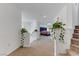 Upstairs hallway with carpet and white walls adorned with decorative plants; Bedroom view at 7180 Grace Estate Ave, Las Vegas, NV 89113