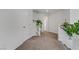 Upstairs hallway with carpet and white walls adorned with decorative plants at 7180 Grace Estate Ave, Las Vegas, NV 89113