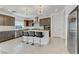 Modern kitchen featuring stainless steel appliances, a kitchen island with barstool seating, and quartz countertops at 7180 Grace Estate Ave, Las Vegas, NV 89113