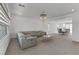 Elegant living room with stylish sectional sofa, modern chandelier, and open dining area at 7180 Grace Estate Ave, Las Vegas, NV 89113